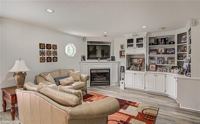 living room with wooden walls and light wood-type flooring