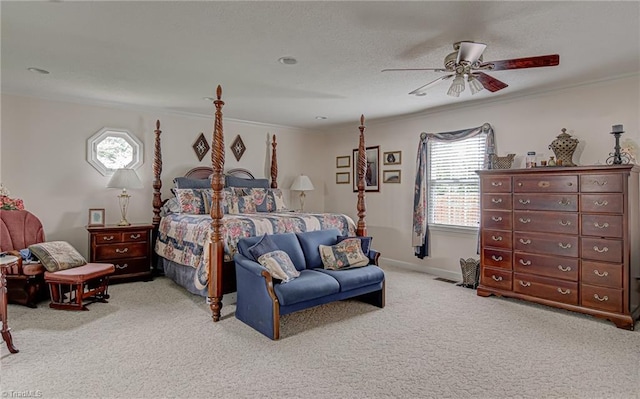 bedroom featuring ornamental molding, light colored carpet, and ceiling fan