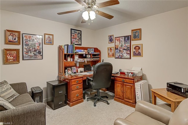 carpeted office space featuring ceiling fan