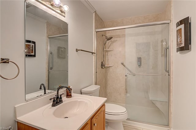 bathroom with vanity, crown molding, walk in shower, and toilet