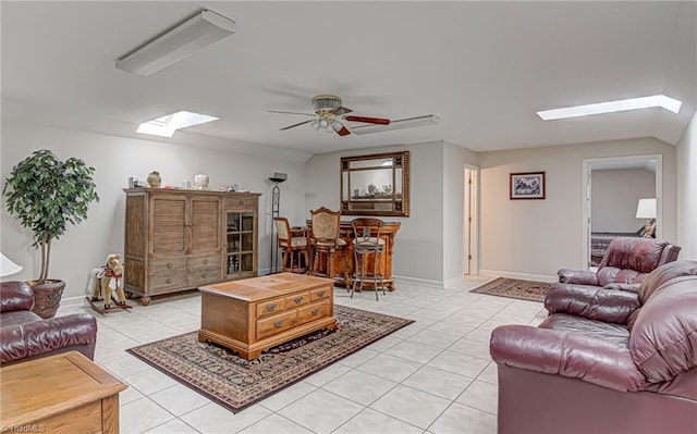 tiled living room with bar area and ceiling fan