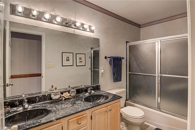 full bathroom with toilet, crown molding, vanity, enclosed tub / shower combo, and a textured ceiling