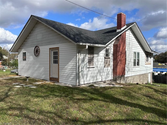 rear view of house with a lawn