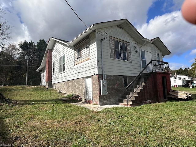 view of property exterior with a lawn