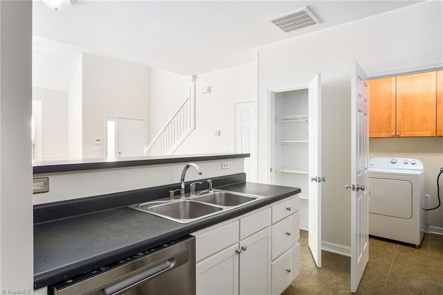 3820 Wayfarer Dr, Greensboro, NC 27410 - kitchen featuring a sink, washer / clothes dryer, dishwasher, dark countertops, and tile patterned floors