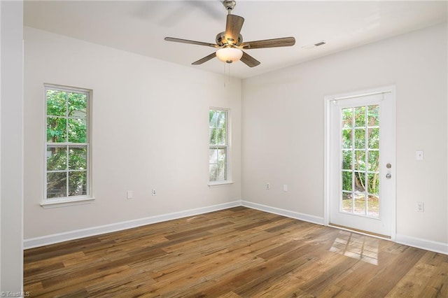 3820 Wayfarer Dr, Greensboro, NC 27410 - spare room with healthy amount of natural light, wood finished floors, ceiling fan, and baseboards