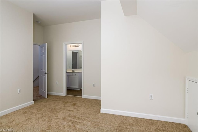 3820 Wayfarer Dr, Greensboro, NC 27410 - unfurnished bedroom with carpet, baseboards, and lofted ceiling