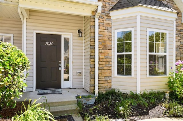 3820 Wayfarer Dr, Greensboro, NC 27410 - entrance to property with a shingled roof and stone siding