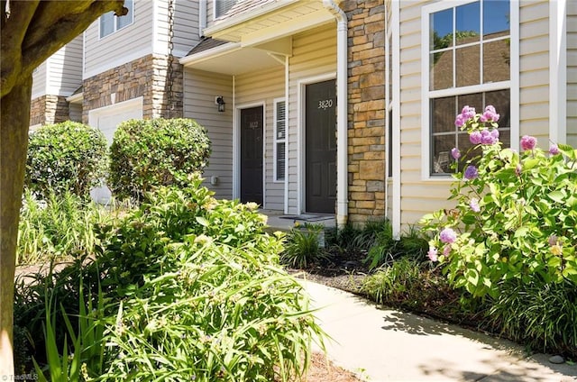 3820 Wayfarer Dr, Greensboro, NC 27410 - view of exterior entry featuring stone siding and a garage