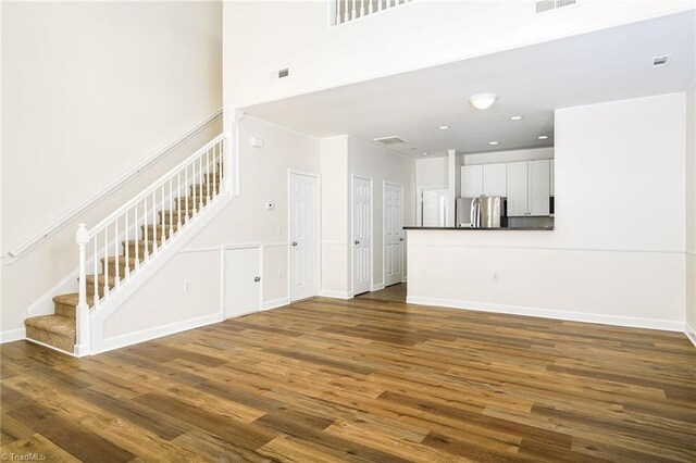 3820 Wayfarer Dr, Greensboro, NC 27410 - unfurnished living room featuring stairway, dark wood finished floors, baseboards, and recessed lighting
