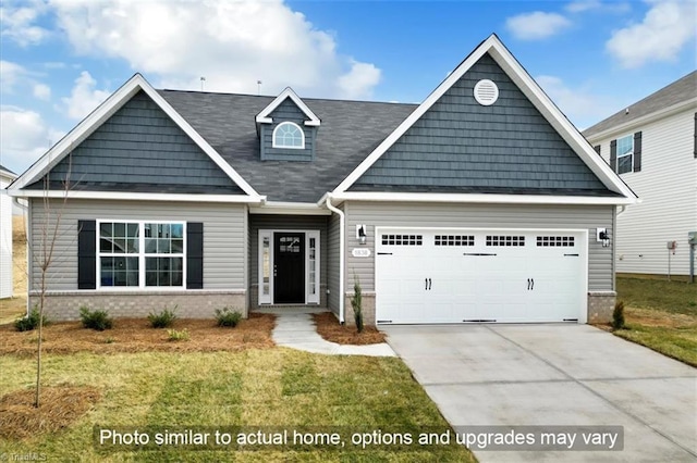 craftsman house with a garage, driveway, a front lawn, and brick siding