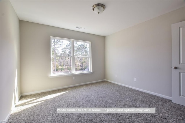 unfurnished room featuring carpet flooring and baseboards