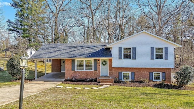 tri-level home with a front lawn and a carport