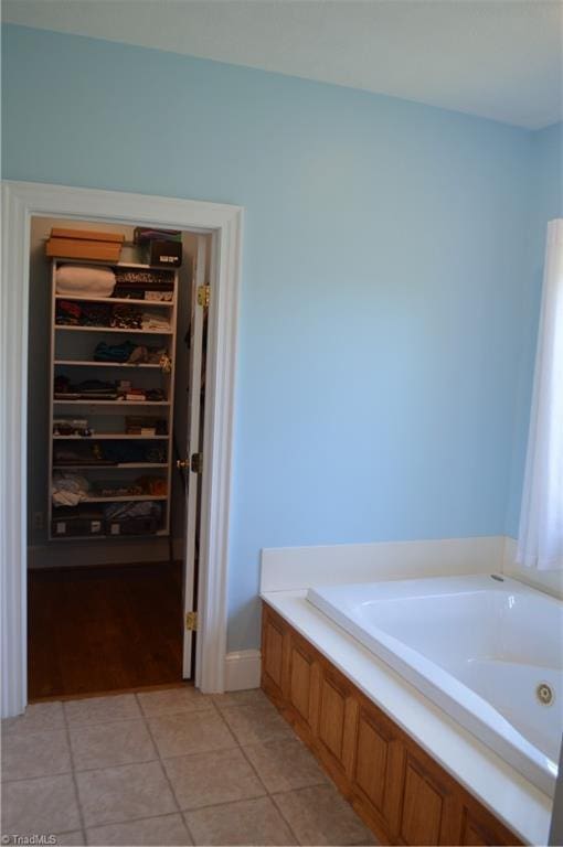 198 Savannah Ln, Mount Airy, NC 27030 - bathroom featuring a whirlpool tub, tile patterned floors, and a spacious closet