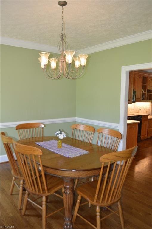 198 Savannah Ln, Mount Airy, NC 27030 - dining room with ornamental molding, a chandelier, dark wood-type flooring, and wainscoting