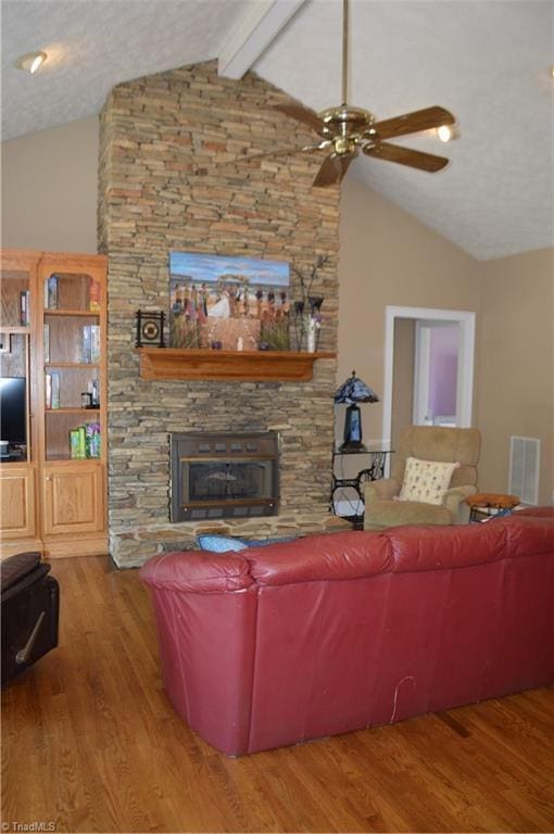 198 Savannah Ln, Mount Airy, NC 27030 - living area with a ceiling fan, a stone fireplace, wood finished floors, beam ceiling, and high vaulted ceiling