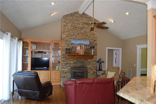 198 Savannah Ln, Mount Airy, NC 27030 - living room with wood finished floors, a fireplace, a ceiling fan, beamed ceiling, and a textured ceiling