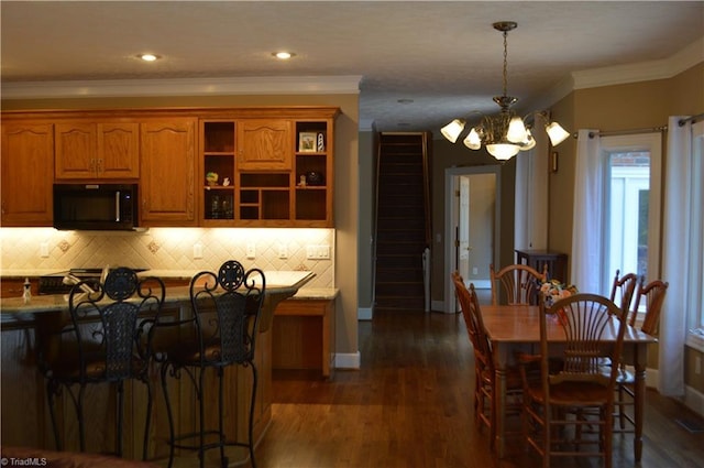 198 Savannah Ln, Mount Airy, NC 27030 - kitchen featuring black microwave, a chandelier, baseboards, decorative backsplash, and decorative light fixtures