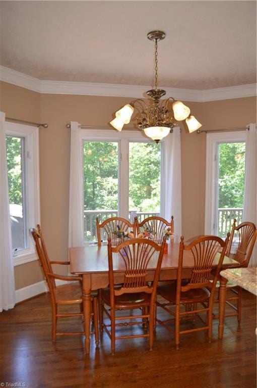 198 Savannah Ln, Mount Airy, NC 27030 - dining room featuring healthy amount of natural light, wood finished floors, baseboards, ornamental molding, and a chandelier