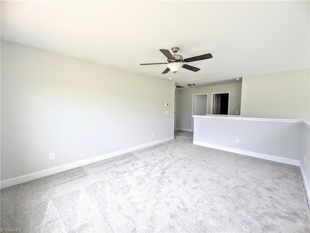 carpeted spare room featuring ceiling fan