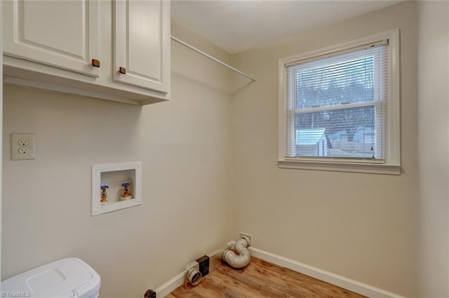 laundry area with cabinets, light wood-type flooring, and hookup for a washing machine