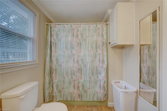 bathroom featuring toilet and crown molding