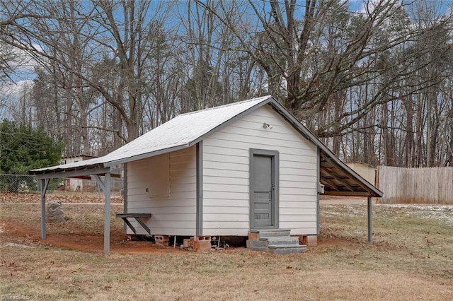 view of outbuilding with a yard and a carport