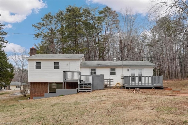 rear view of property with a lawn and a deck