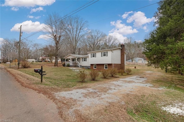 view of front of property with a porch and a front yard