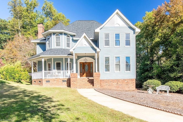 112 Havenwood Dr, Archdale, NC 27263 - victorian house with a front lawn, a shingled roof, a porch, and a chimney