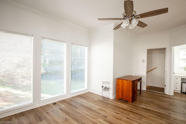 empty room featuring ceiling fan, ornamental molding, and hardwood / wood-style floors