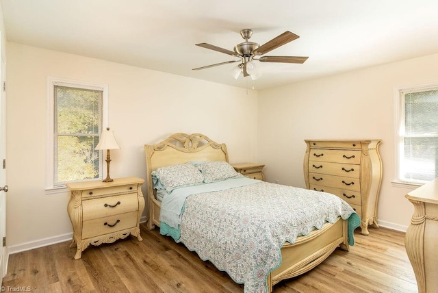 bedroom with ceiling fan and light hardwood / wood-style flooring