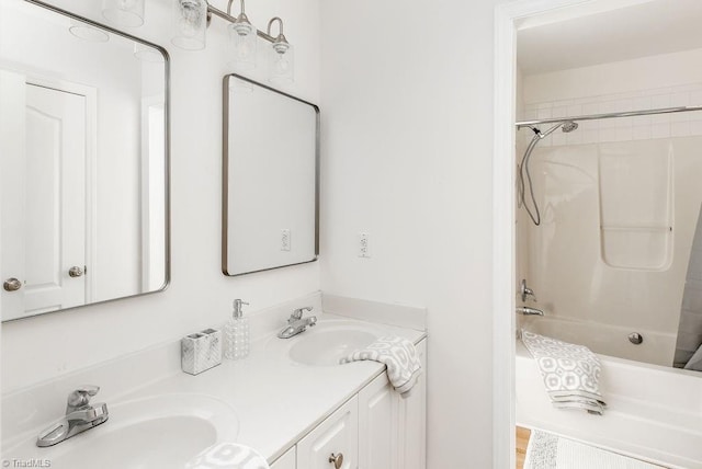 bathroom with vanity and shower / washtub combination