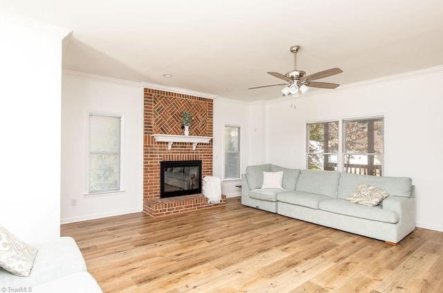 living room with ornamental molding, light wood-type flooring, and a fireplace