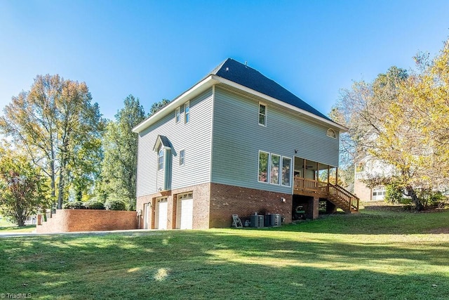 112 Havenwood Dr, Archdale, NC 27263 - back of property with a lawn, brick siding, an attached garage, stairs, and central air condition unit