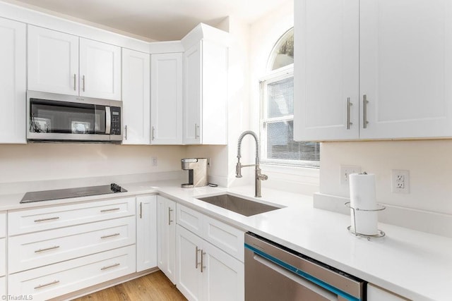 112 Havenwood Dr, Archdale, NC 27263 - kitchen with white cabinets, light countertops, stainless steel appliances, and a sink