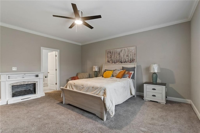 carpeted bedroom featuring ceiling fan, a premium fireplace, connected bathroom, and ornamental molding