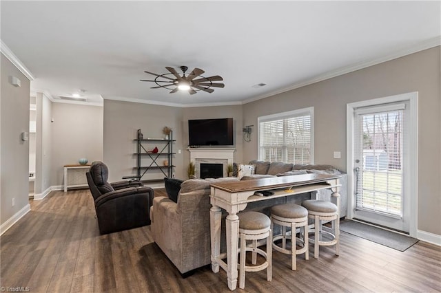 living room with ceiling fan, crown molding, and hardwood / wood-style floors