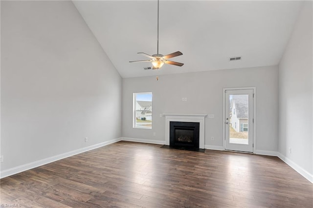 unfurnished living room with ceiling fan, a healthy amount of sunlight, and dark hardwood / wood-style floors