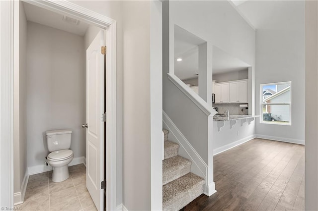 stairway with tile patterned flooring