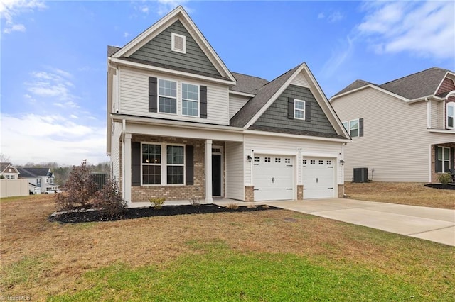 view of front of property featuring a garage, central AC, and a front lawn