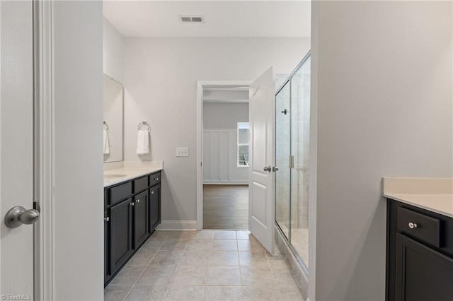 bathroom with vanity, an enclosed shower, and tile patterned flooring