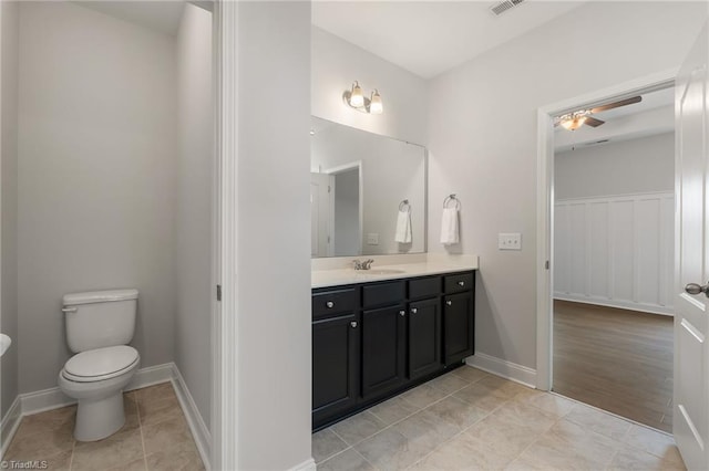 bathroom featuring vanity, tile patterned flooring, and toilet