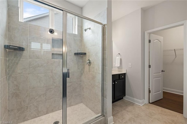 bathroom with vanity and a shower with shower door