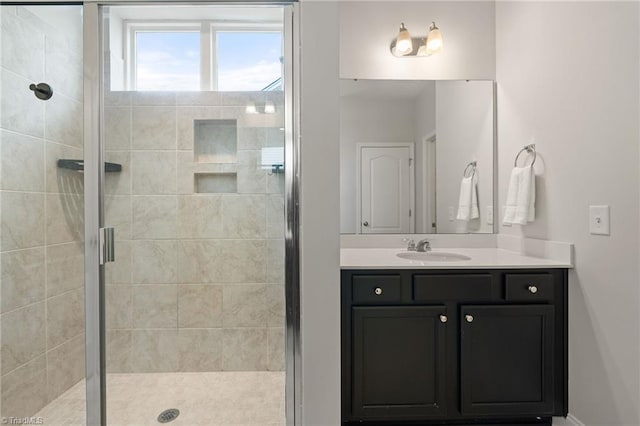 bathroom with vanity and a shower with door