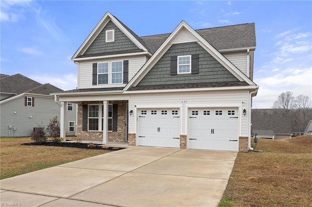 craftsman house with a garage, covered porch, and a front lawn