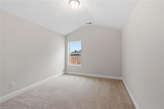 interior space featuring vaulted ceiling and carpet