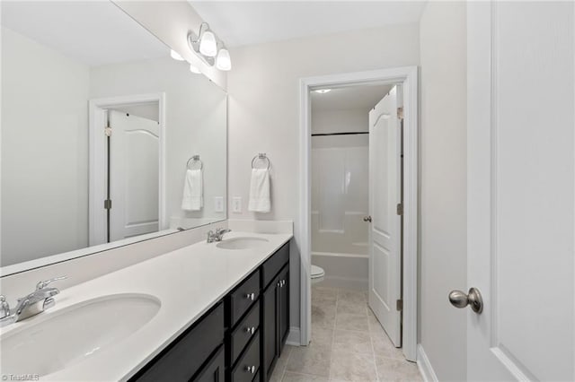 full bathroom with tile patterned flooring, vanity, tub / shower combination, and toilet