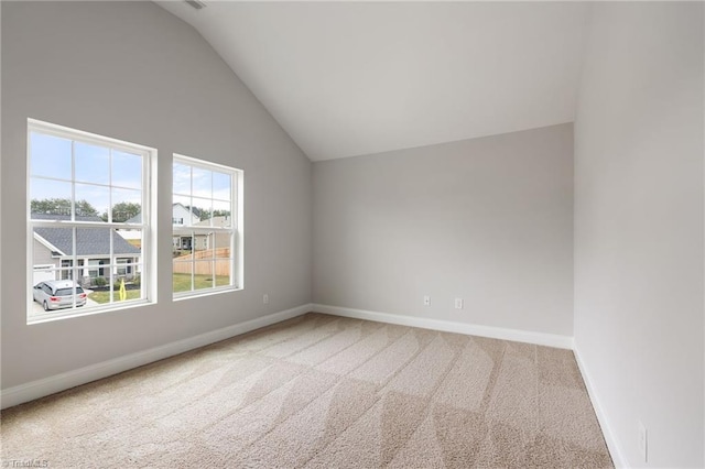 unfurnished room featuring vaulted ceiling and carpet