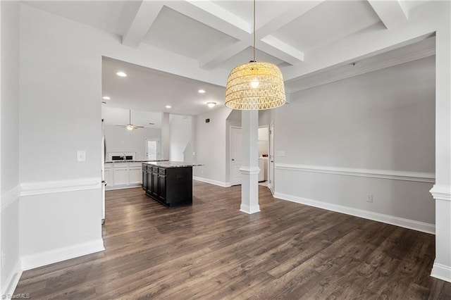 unfurnished living room with beam ceiling, dark wood-type flooring, decorative columns, and ceiling fan